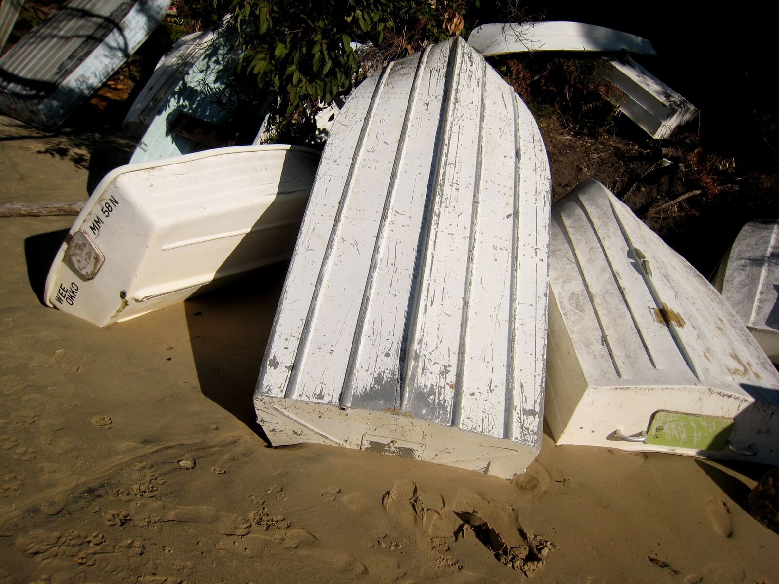 Aluminium tinnies pulled up on the sand